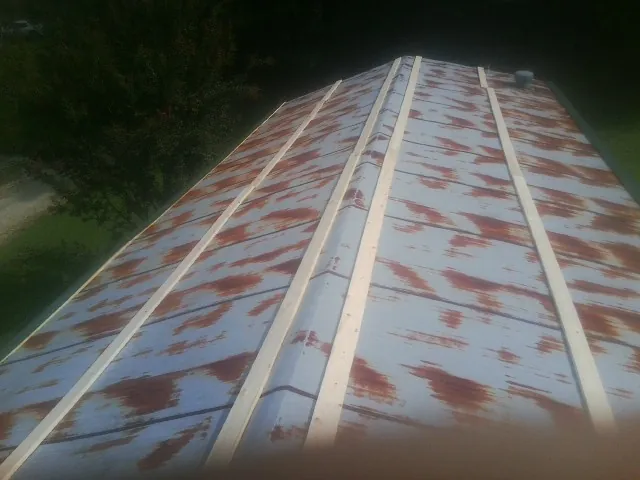 Rusted metal roof panels with new wood purlins before replacement — Storm Damage Roof Repair in Kauneonga Lake by Roofing Brothers