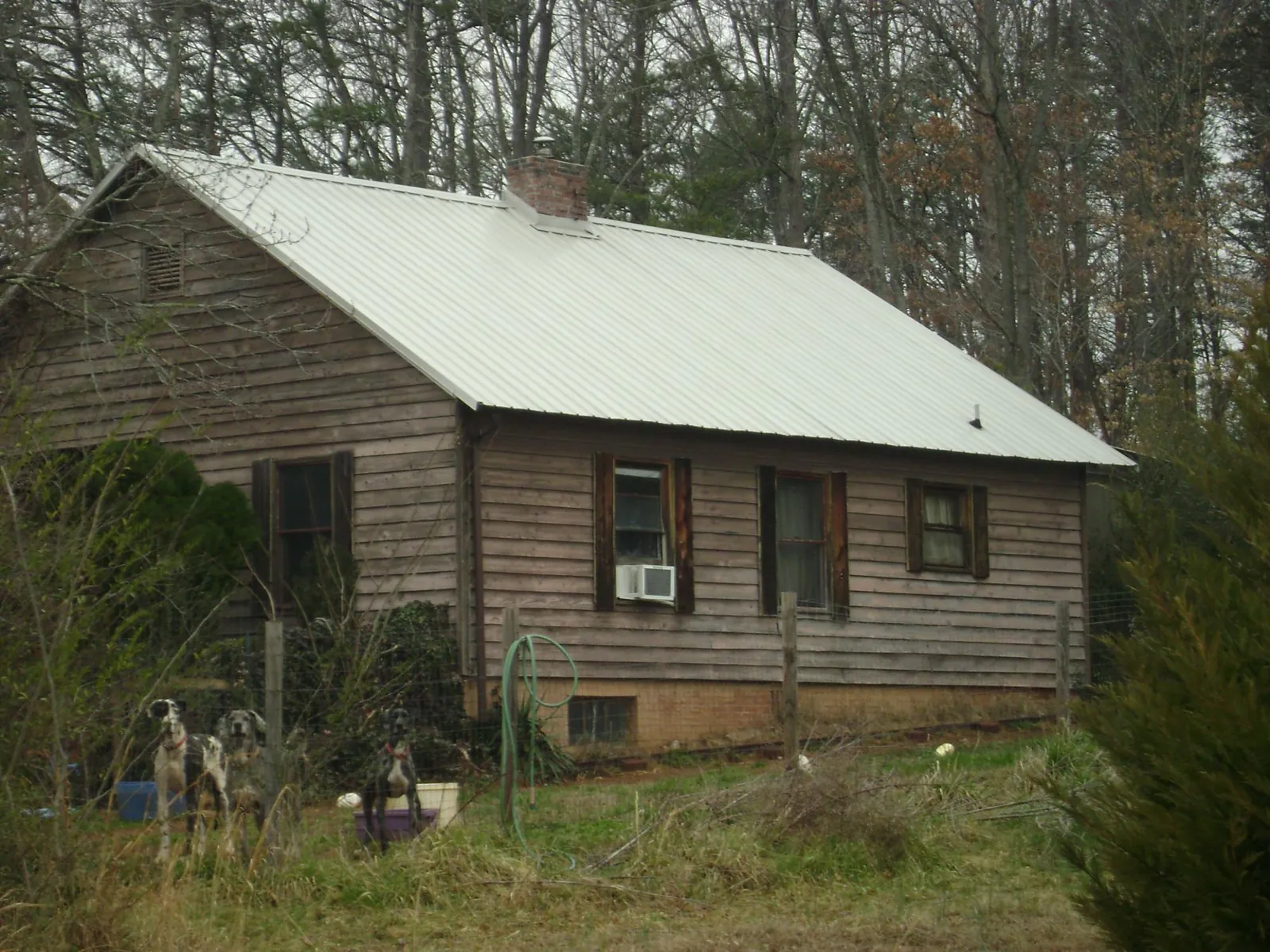 White metal roof on an old wood sided farmhouse, from a Metal Roof Installation job in Kauneonga Lake